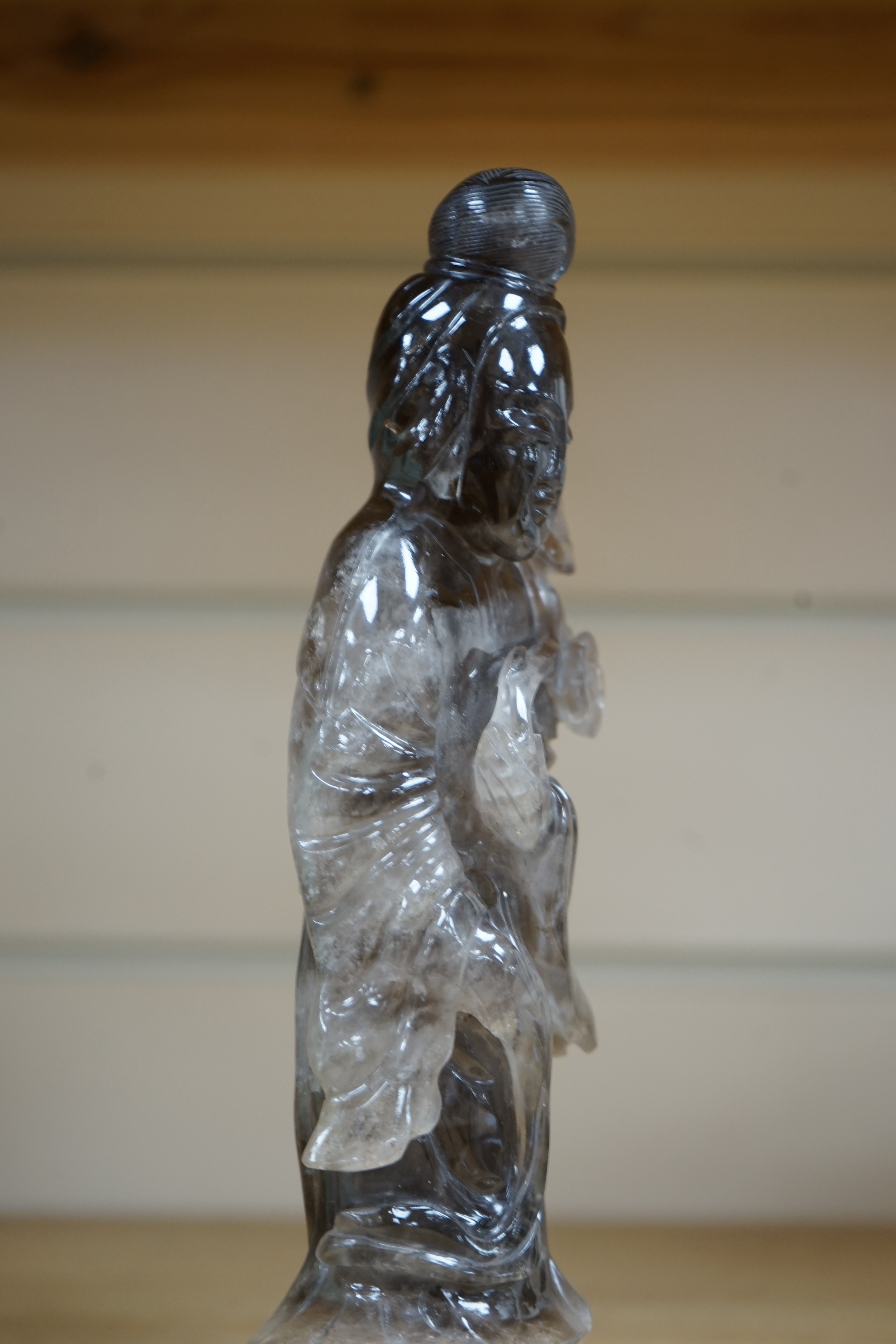 A Chinese smoky quartz figure of Guanyin, 23cm. Condition - fair to good